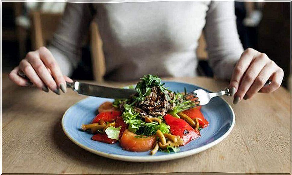 A woman is eating a meal.