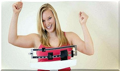 A woman celebrates her weight loss.