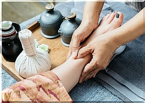A foot is massaged to relieve joint pain