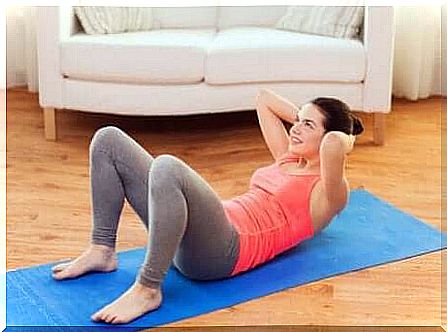 Woman doing sit-ups on mat